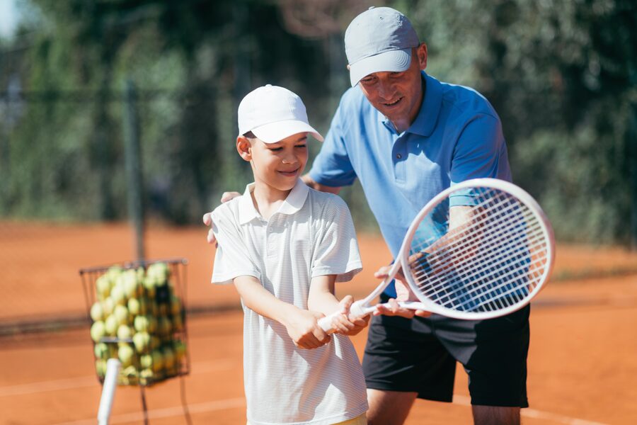 Tennis coach teaching grip
